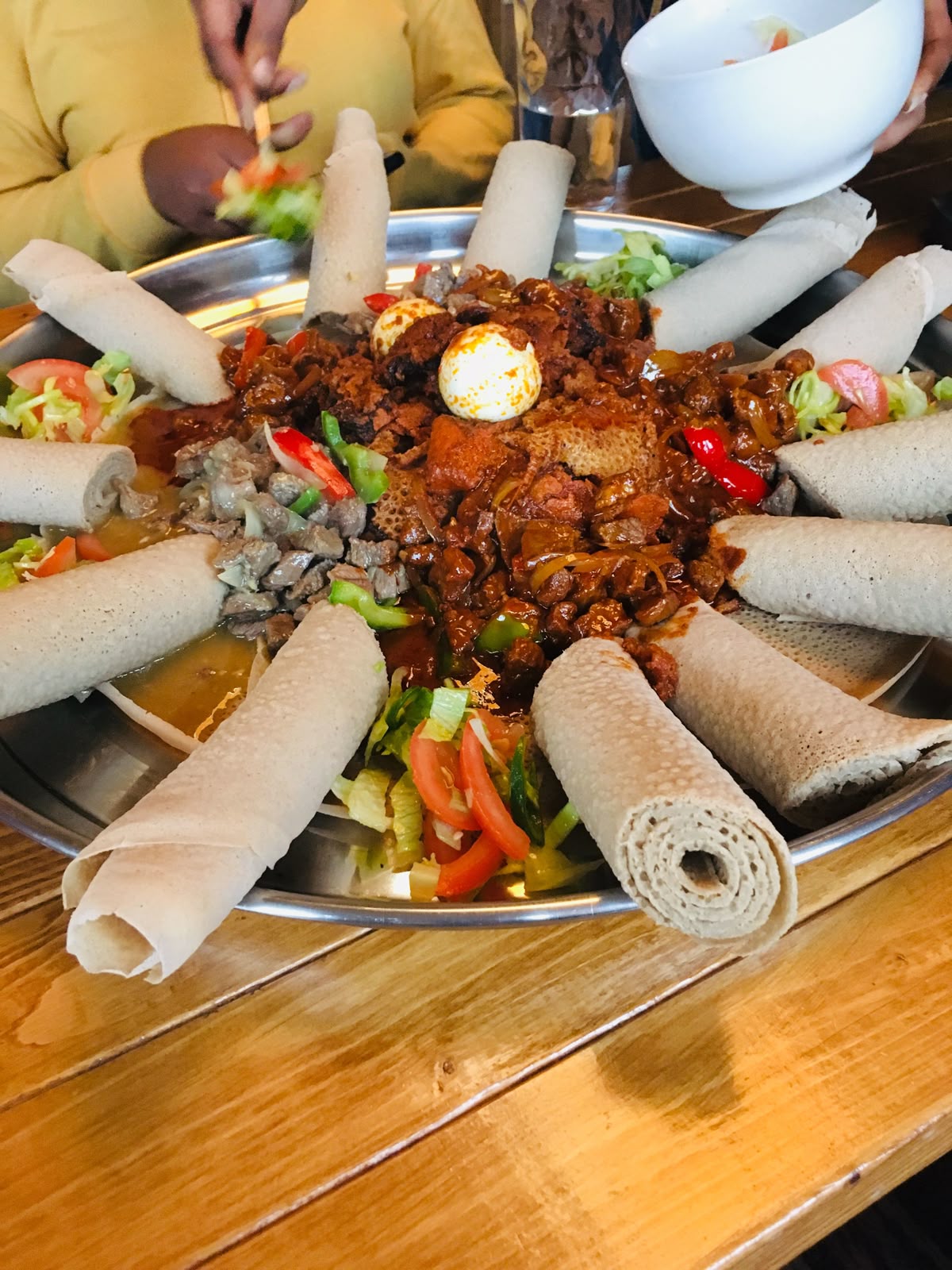 People sharing Ethiopian food communally